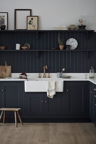 Kitchen with charcoal cabinets, sink, and open shelving by Kitchen Makers