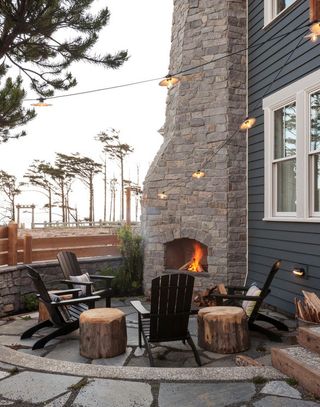 rustic outdoor seating area with built in fireplace