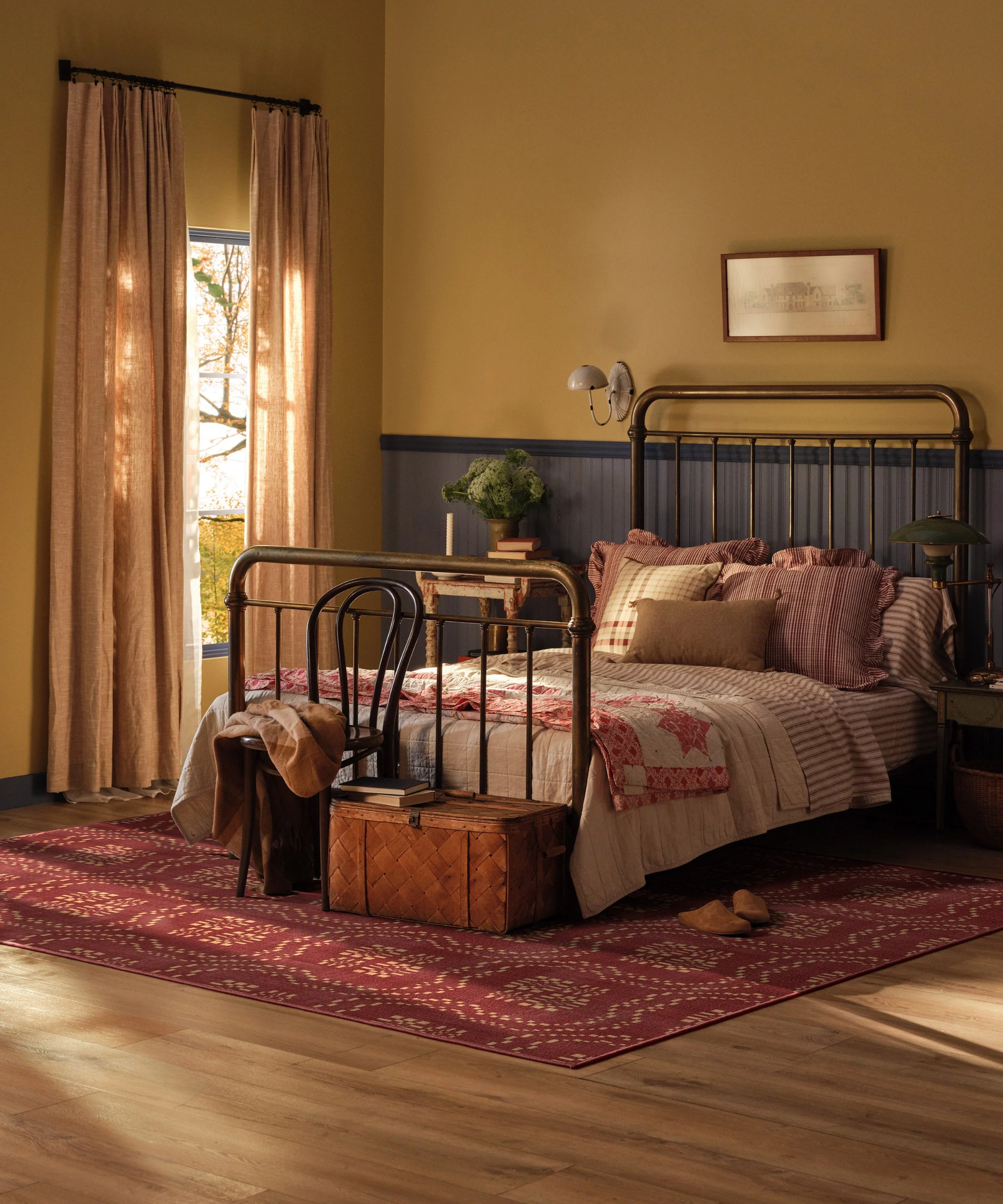 a vintage-inspired bedroom with a deep red rug on the floor