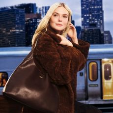 Elle Fanning wearing a Coach Teddy Coat and a Brooklyn Bag