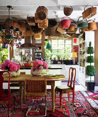 kitchen diner with baskets hanging from ceiling and turkish style rug