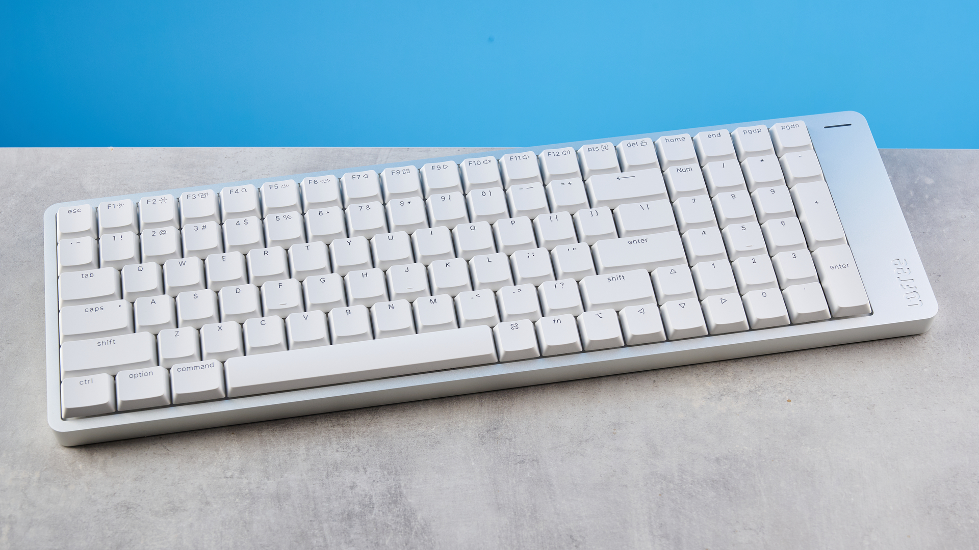 The Lofree Flow 2 on a stone surface with a blue background