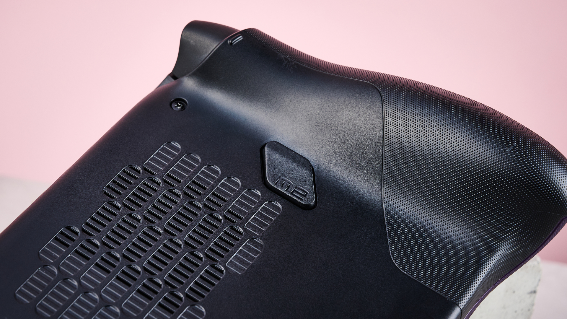 A closeup of the rear of the MSI Claw 8 EX AI+, showing its left macro button.