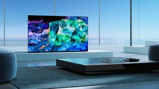 The Sony XR-A95K TV pictured in a grey living room displaying a blue and green abstract shot
