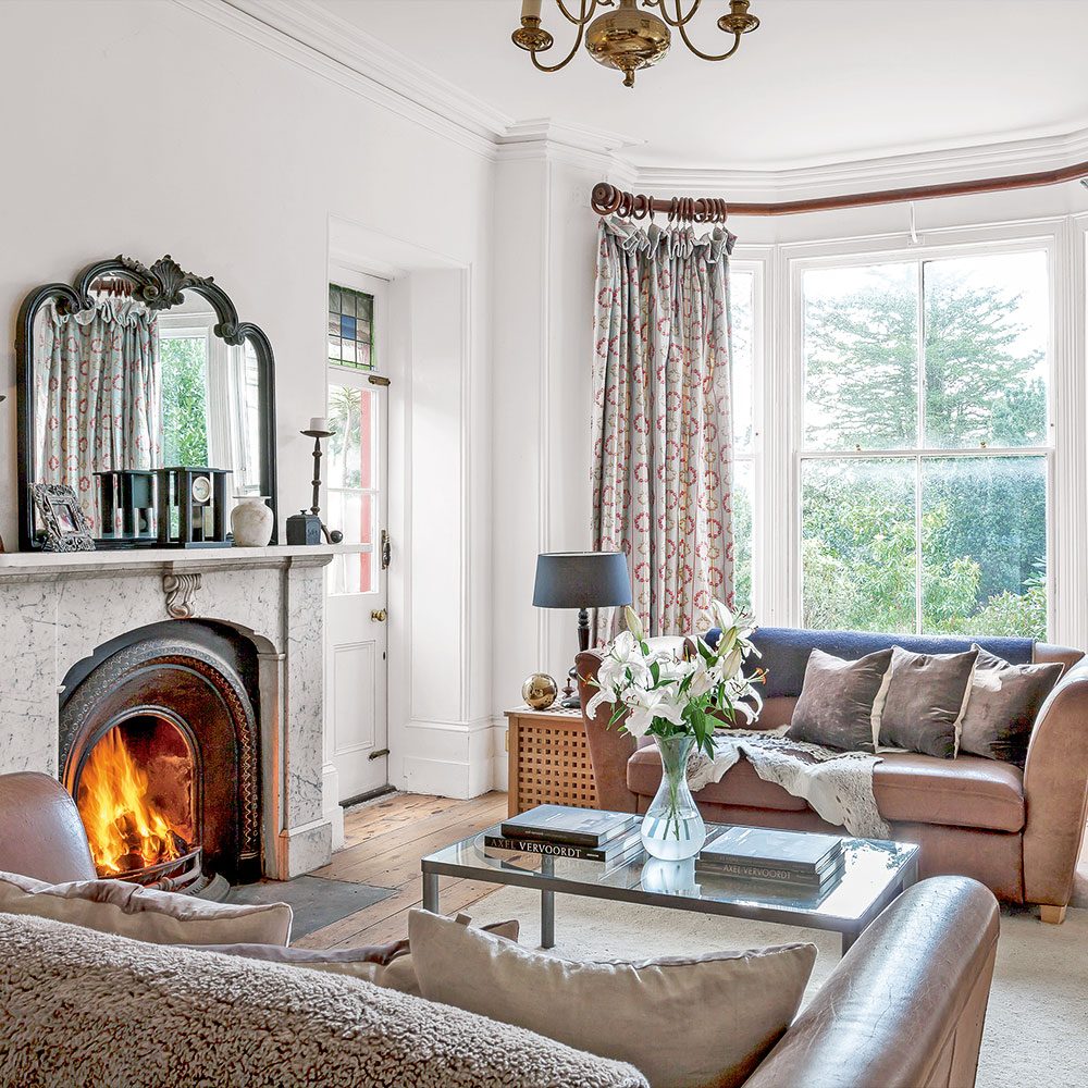 living room with wooden flooring and white marble fireplace