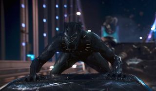 Black Panther T'challa in costume on top of a car