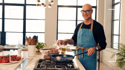 Picture of actor Stanley Tucci in Kitchen using the Stanley pan from his TUCCI by GreenPan Cookware Collection 