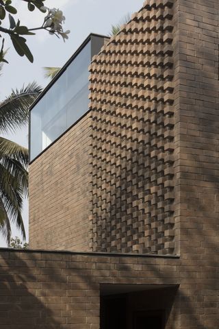 Brick house with clever brickwork and openings define the facades