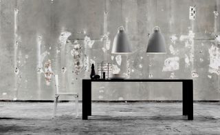 Image of a grey scene with a chair & table and two low hanging lights above