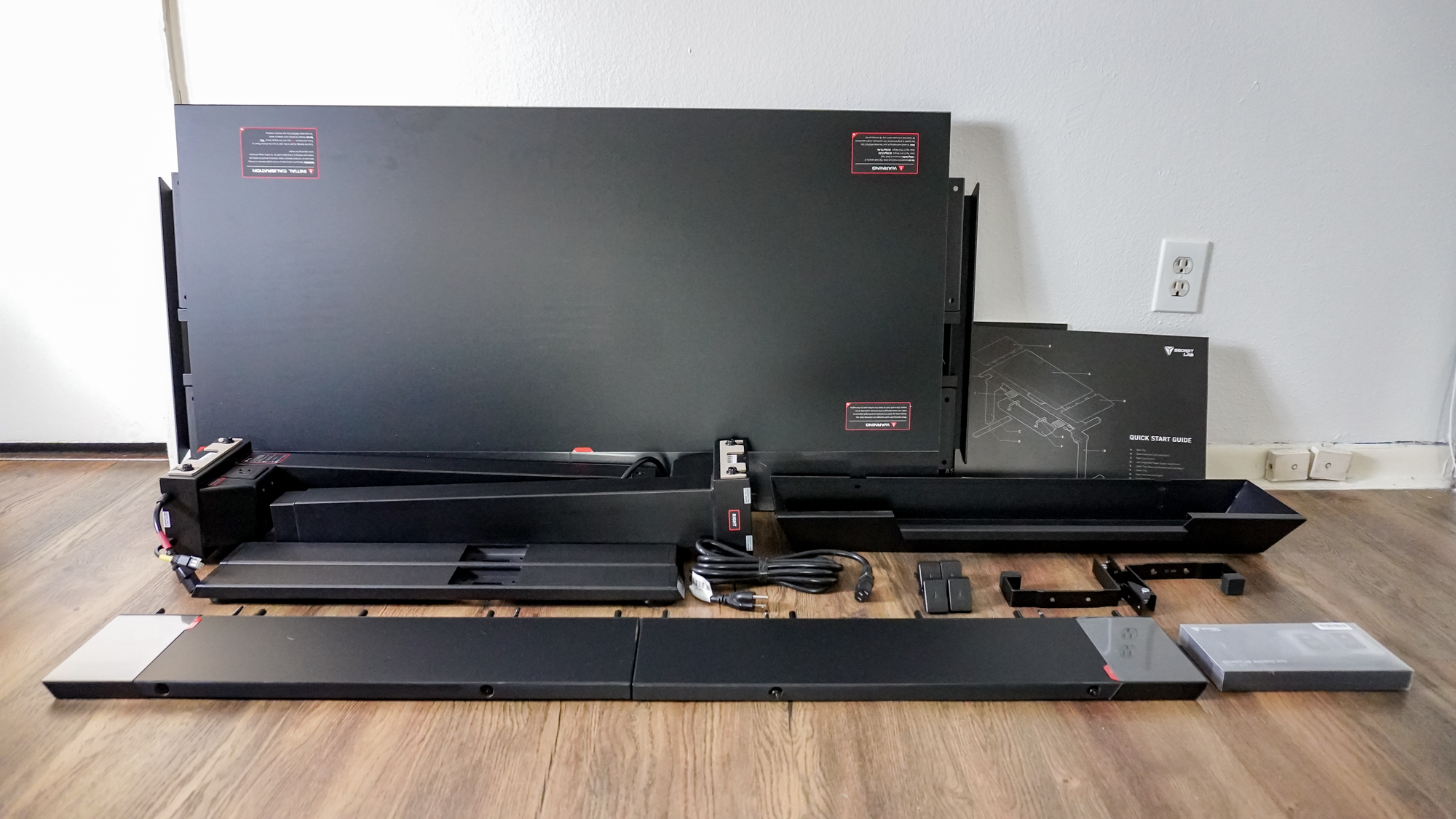 The Secretlab Magnus Evo unboxed with all of its parts on laid out on the floor