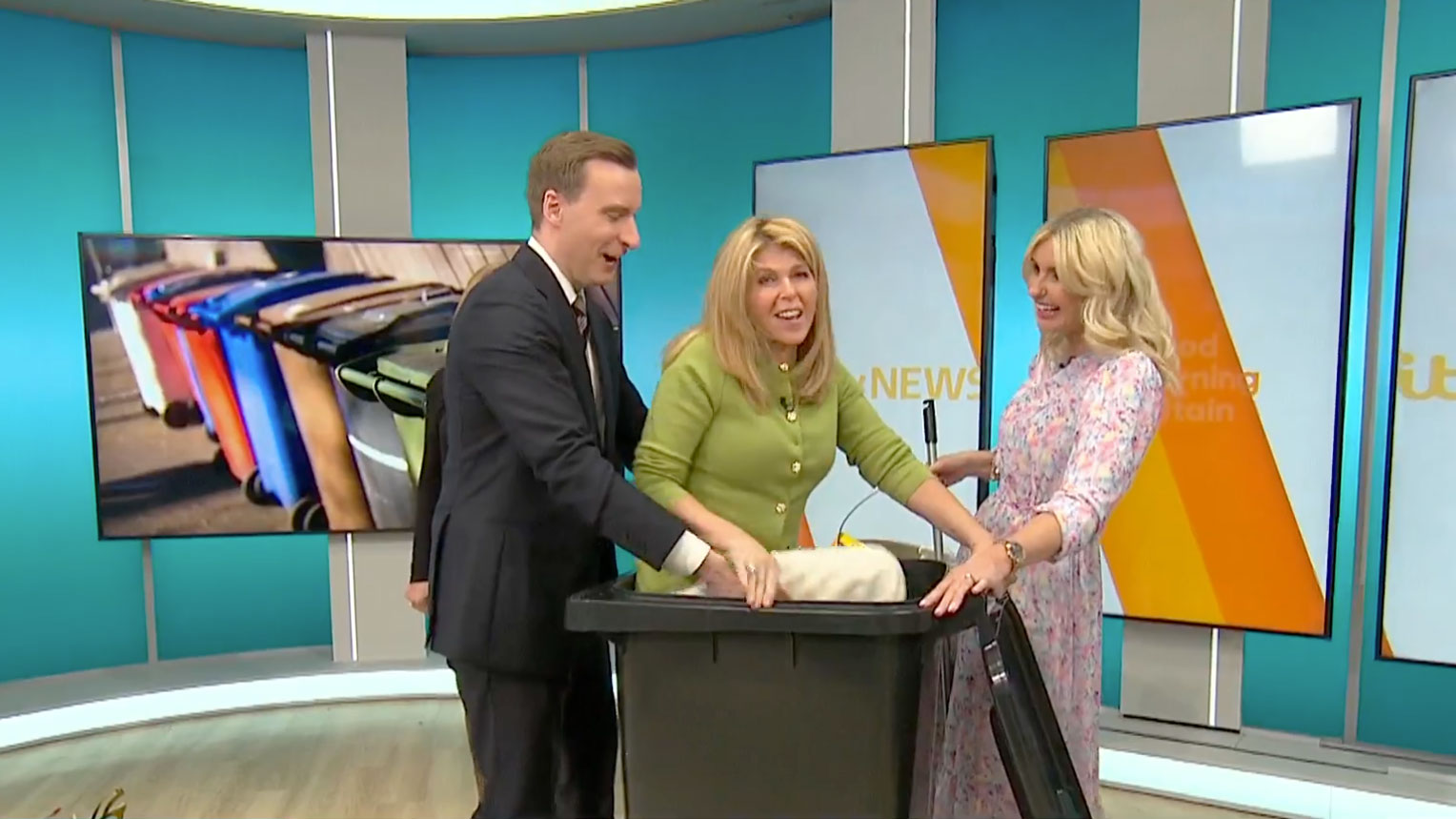 Kate Garraway climbing into a wheelie bin on the set of ITV's Good Morning Britain