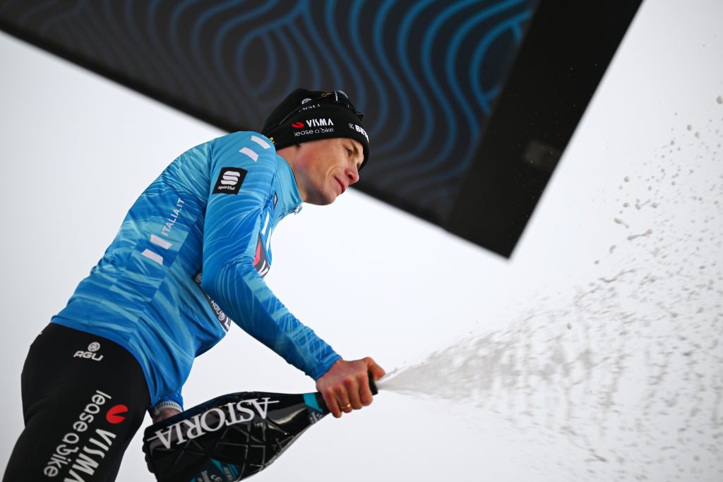 Jonas Vingegaard sprays prosecco on the podium of stage six of Tirreno-Adriatico