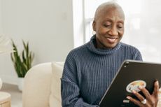 Older woman looking at tablet. 