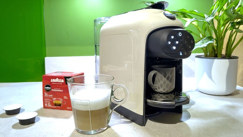 Lavazza A Modo Mio Des&eacute;a coffee maker with coffee capsules and plant on kitchen counter