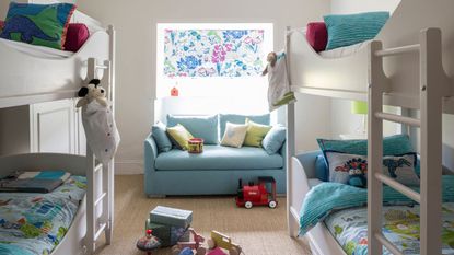 Bunkbeds in room with blue sofa