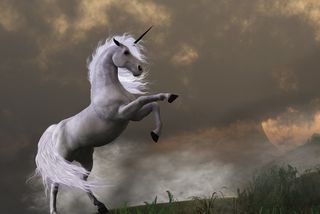 A unicorn rearing on a hill