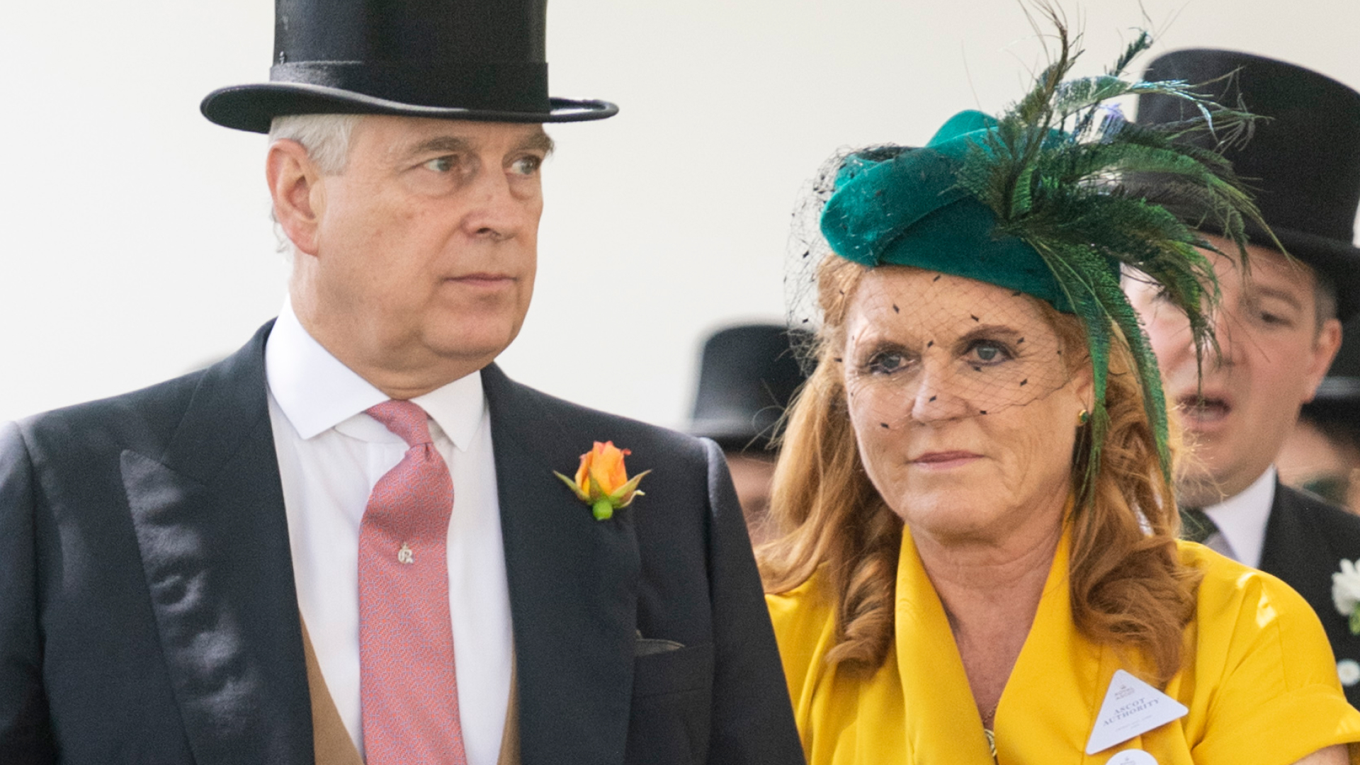 Prince Andrew wears a top hat and tails while his ex-wife Sarah Ferguson wears a bright yellow dress with a green feathered hat