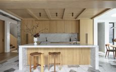 A kitchen with a marble island 