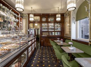 An old-style patisserie features Art Deco-inspired decor in tones of golden and green.