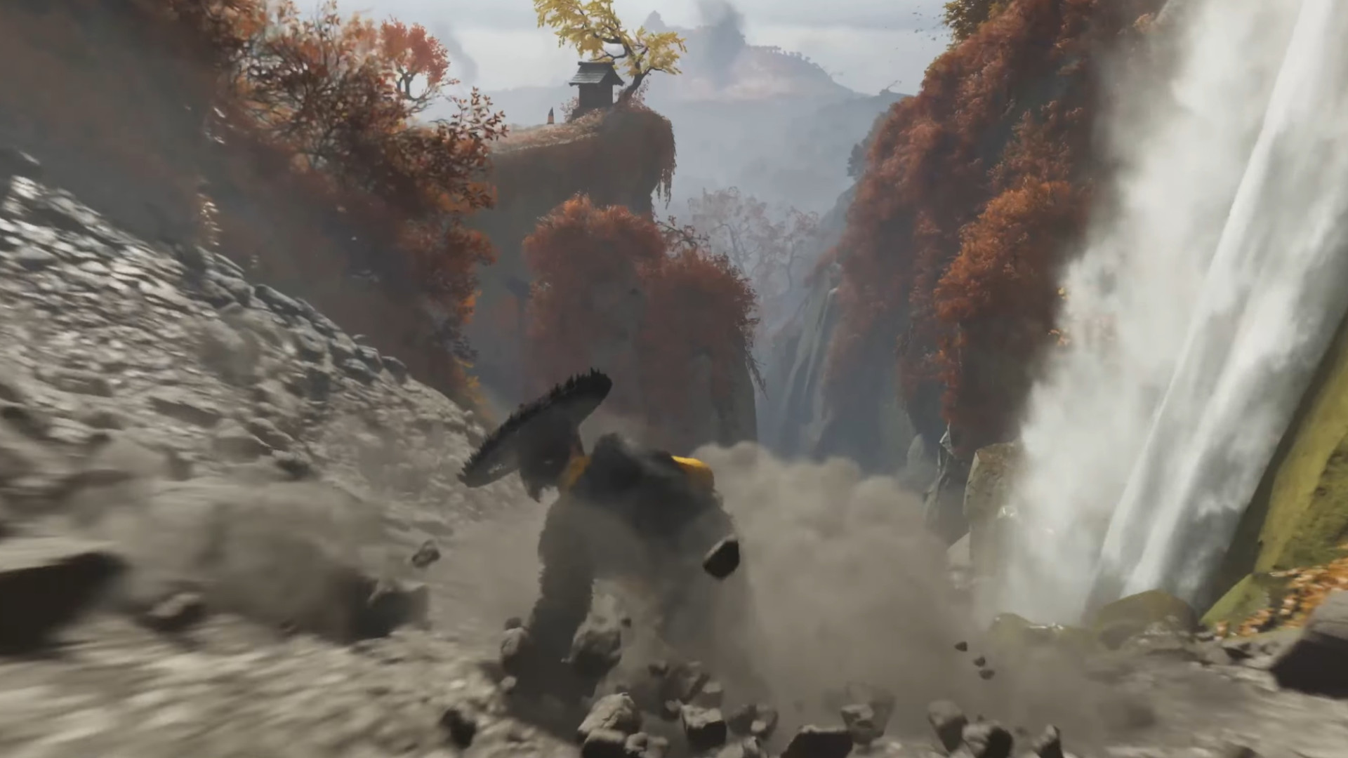 Trying to reach a shrine in Ghost of Yotei, Atsu slides down a rocky cliff and hurtles towards a waterfall