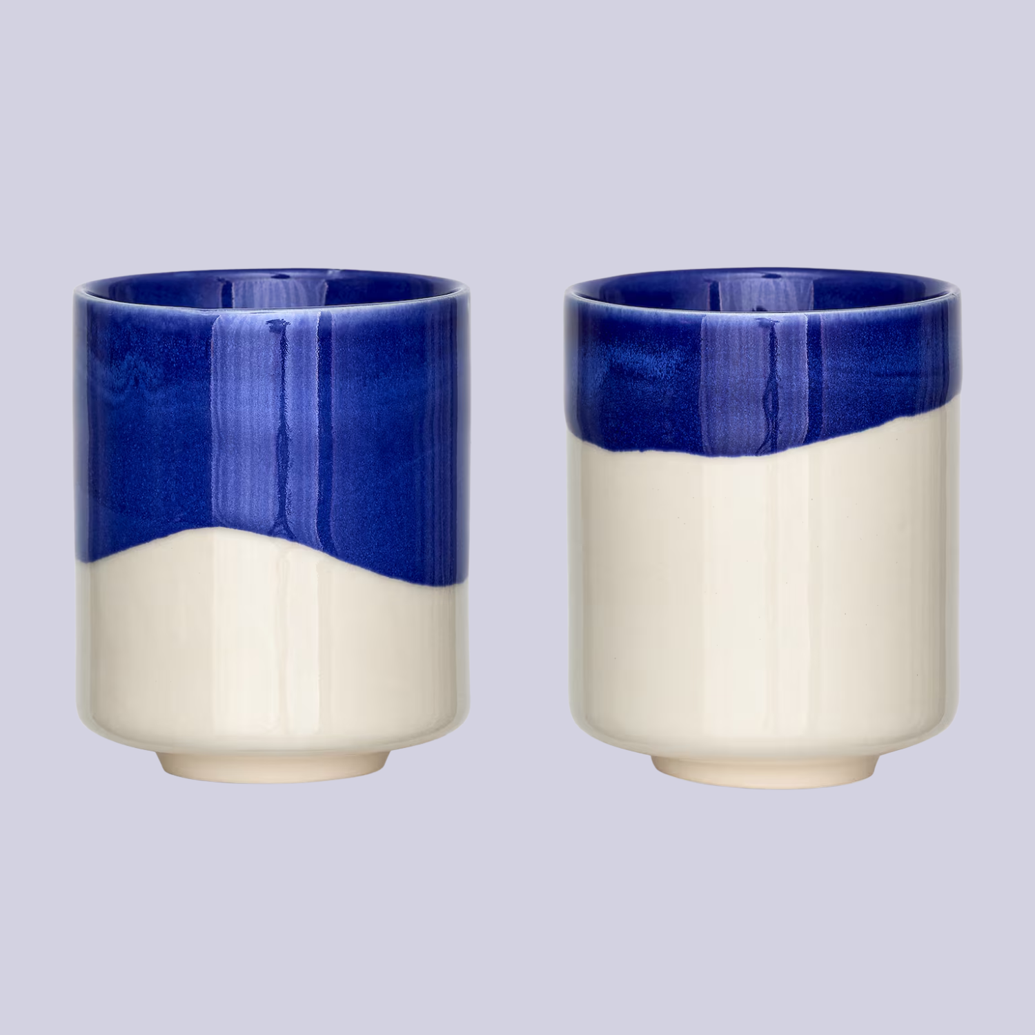 An off-white and blue dip ceramic mug set