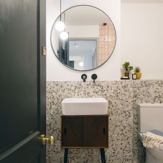 bathroom with mirror on wall and white basin