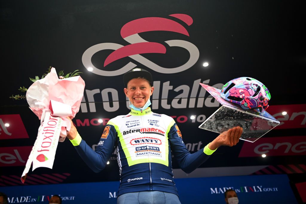CANALE ITALY MAY 10 Taco Van Der Hoorn of Netherlands and Team Intermarch Wanty Gobert Matriaux celebrates at podium during the 104th Giro dItalia 2021 Stage 3 a 190km stage from Biella to Canale Trophy Kask Utopia Giro Helmet designed by MotoGP artist Aldo Drudi to stage winners girodiitalia Giro on May 10 2021 in Canale Italy Photo by Stuart FranklinGetty Images