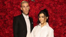 travis barker and kourtney kardashian on a red rose background