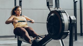 Woman using rowing machine