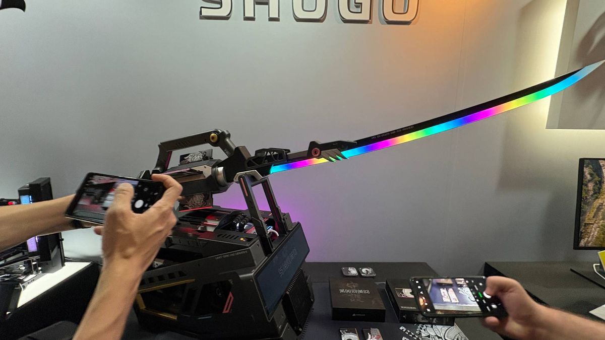 An RGB samurai sword on a pedestal that is actually a PC. The words 'Shugo' can be seen on the wall behind the exhibition piece from Corsair.