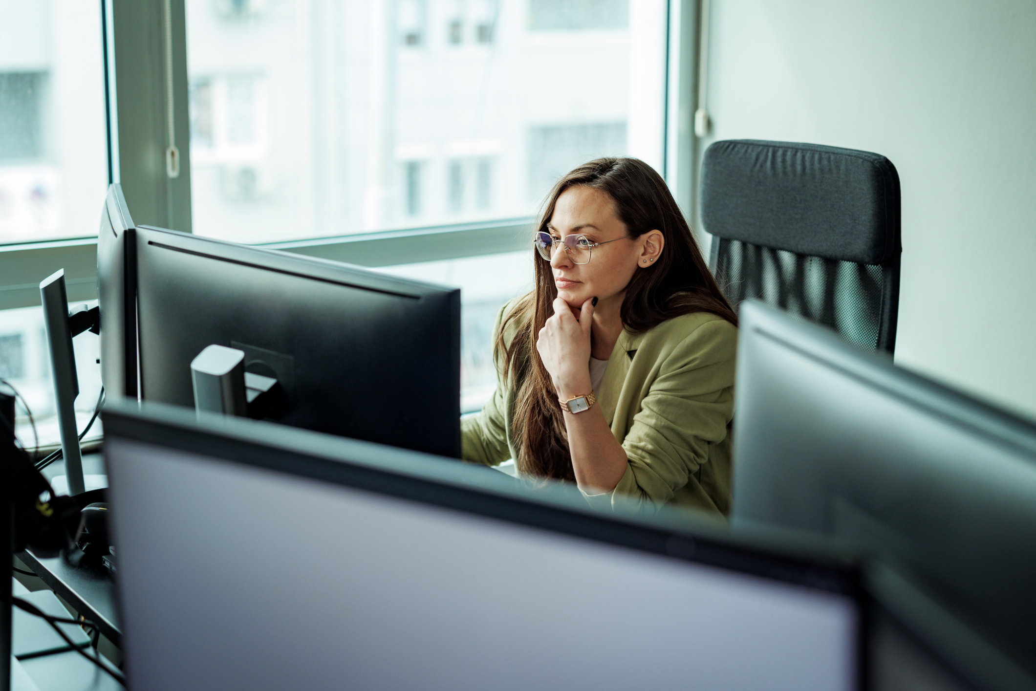 Mortgage underwriter going over a file on her computer