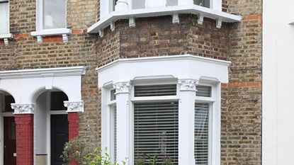 bricked house exterior with white windows