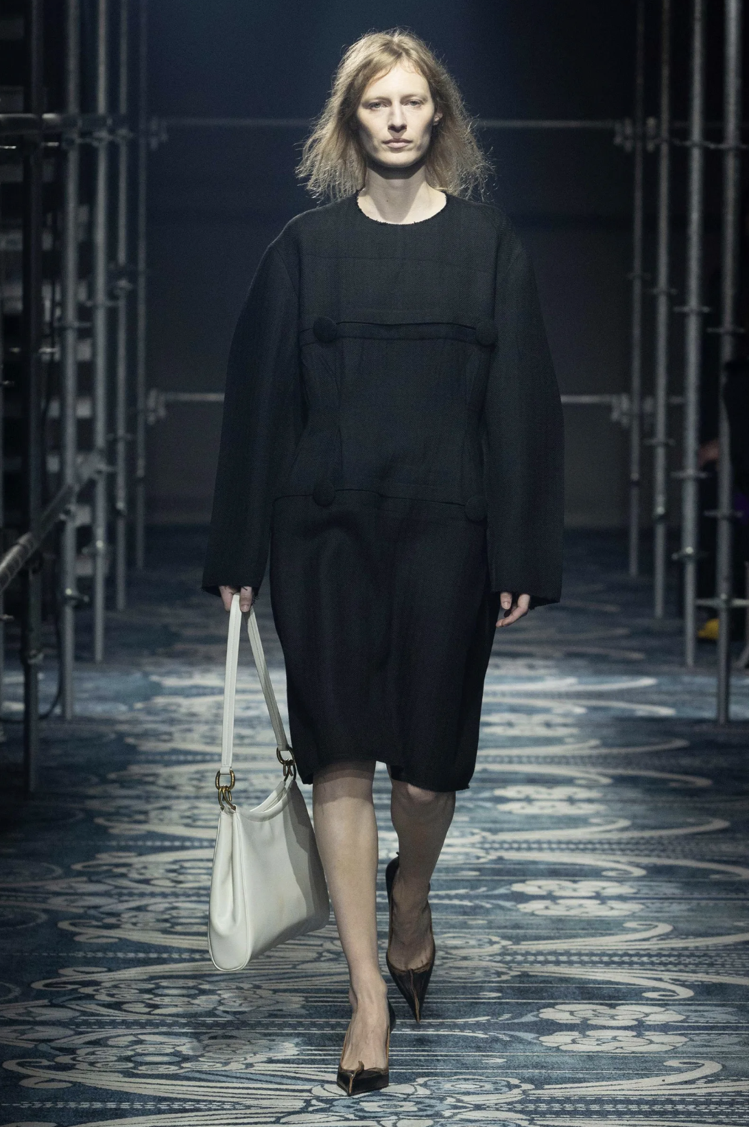 Prada model wears black dress