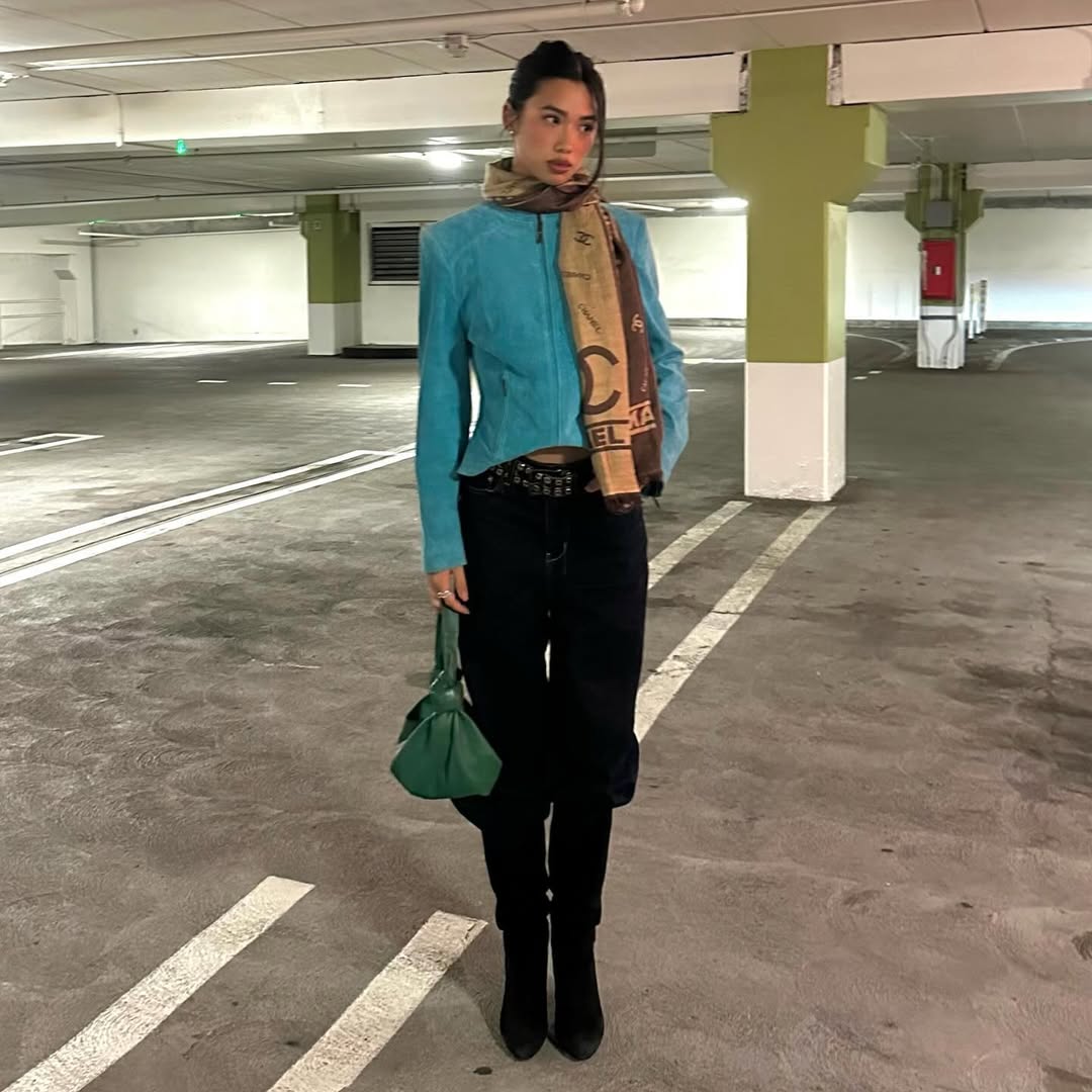Woman wearing boots tucked into jeans trend fall 2025.