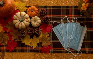 Masks next to Thanksgiving decorations.