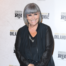 Dawn French in all balck smiling on red carpet.