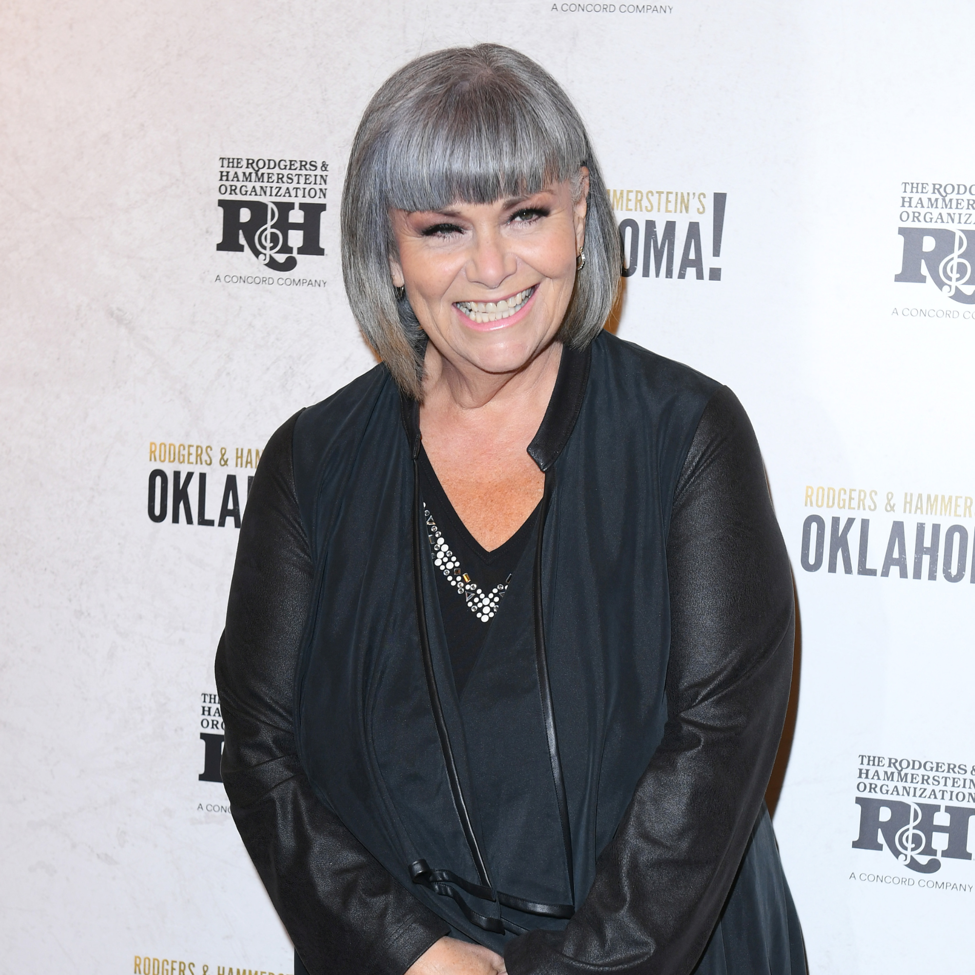 Dawn French in all balck smiling on red carpet.