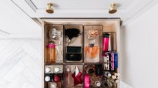 Clean and organized drawer of perfume and makeup