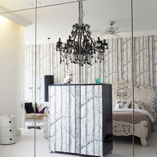 bedroom with textured wall and black wardrobe with white texture
