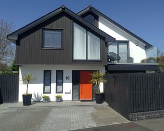 an orange front door on a self build house