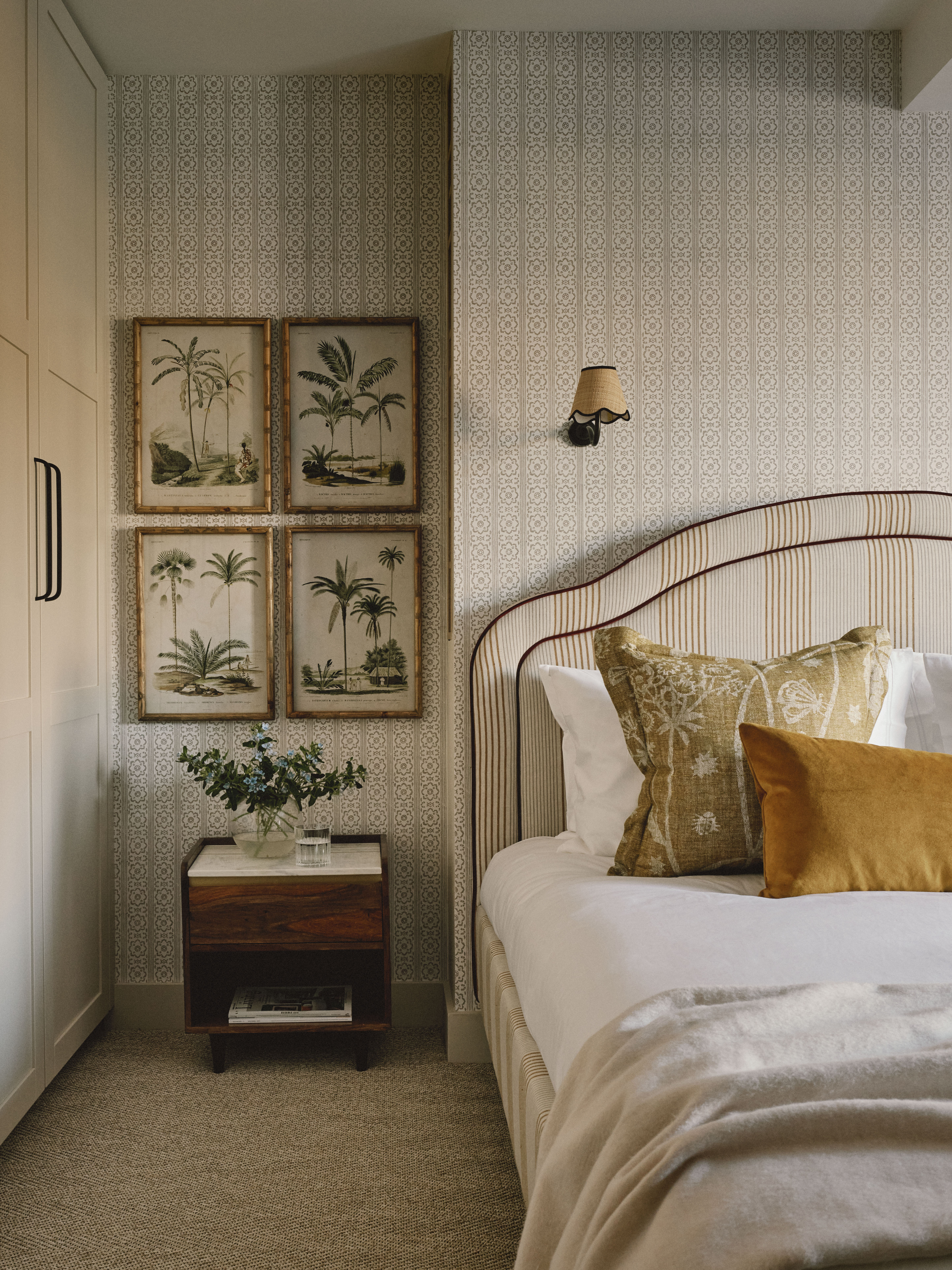 Greige bedroom with botanical prints and mustard cushions by Interior Fox