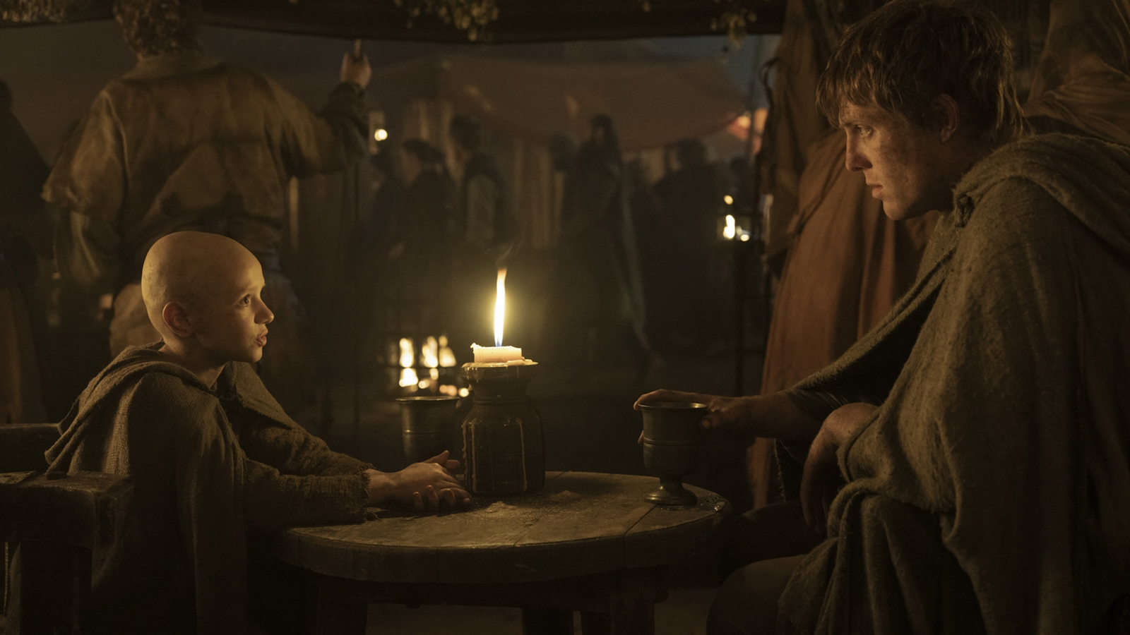 Egg and Dunk sitting at a table in a tent lit by candlelight in A Knight of the Seven Kingdoms