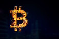 image of bitcoin symbol on fire with black background