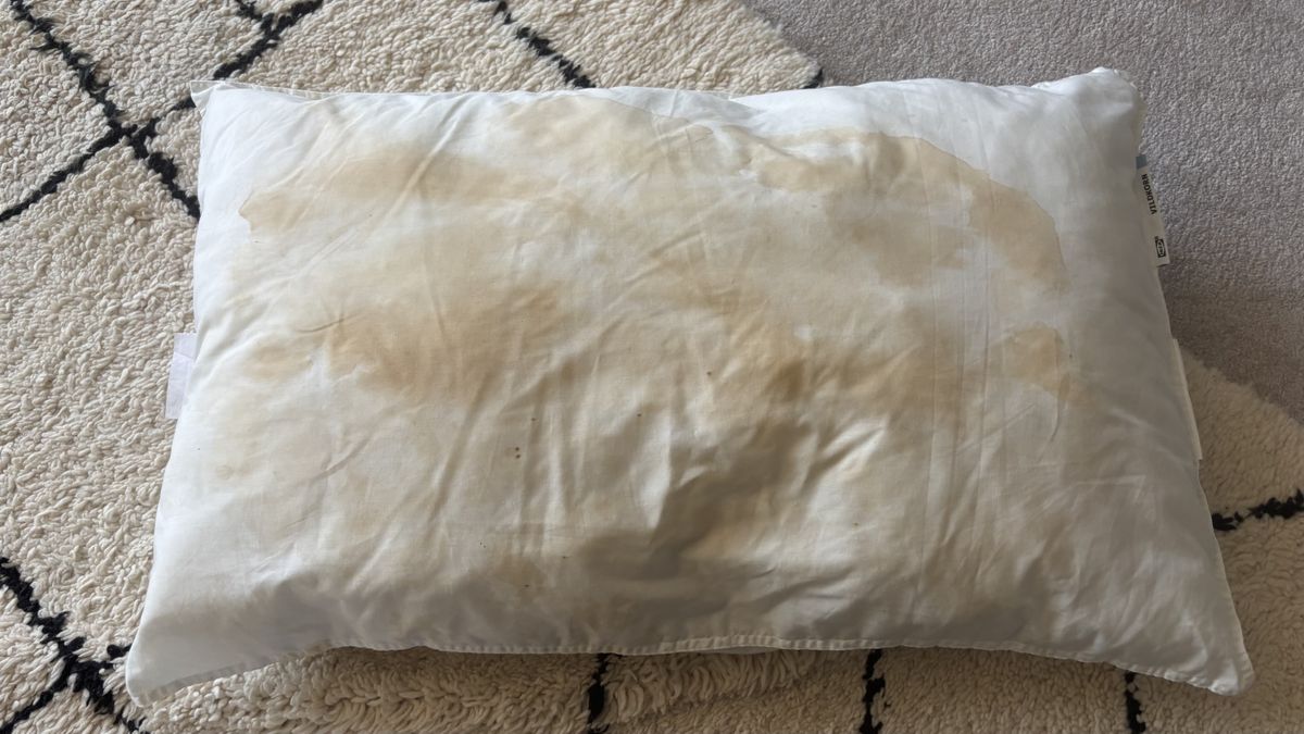 A stained pillow before being washed with detergent and soda crystals.
