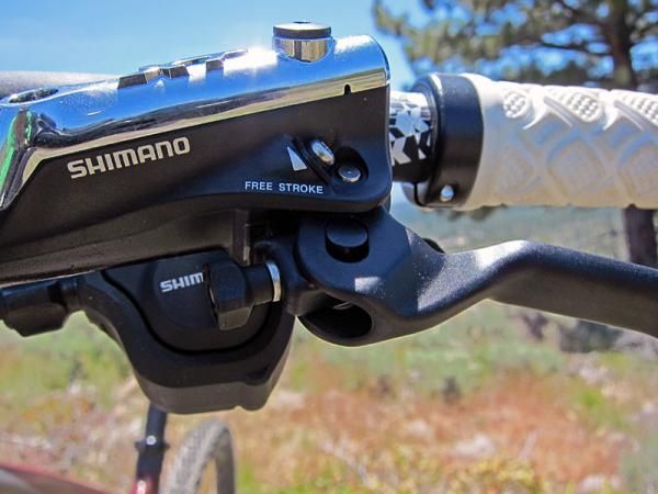 Reach is adjusted via the handy knob on Shimano's new Deore XT brake levers while pad contact point is unfortunately still tweaked via a small Phillips-head screw.