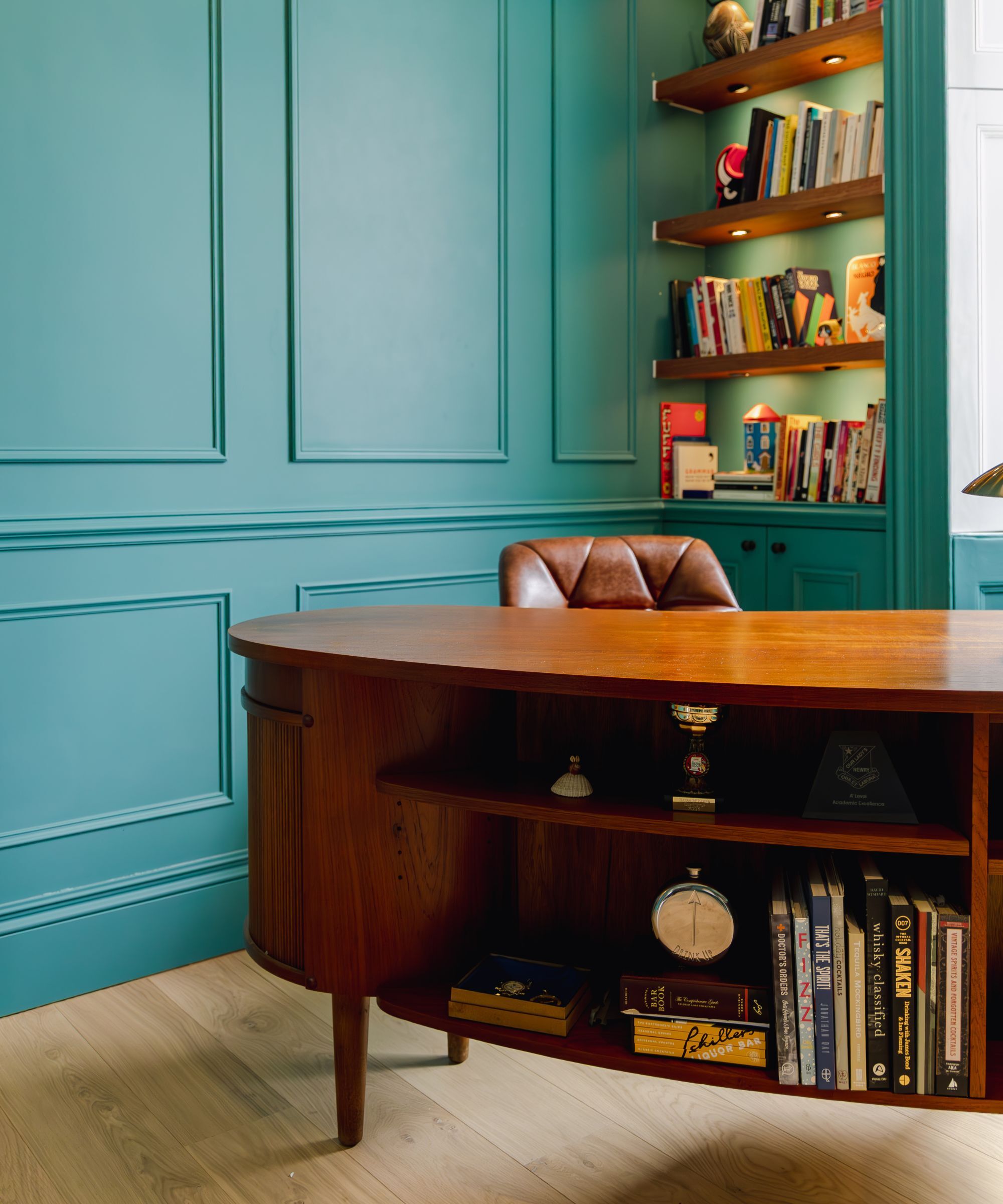 An office space with panelled walls painted in azure blue