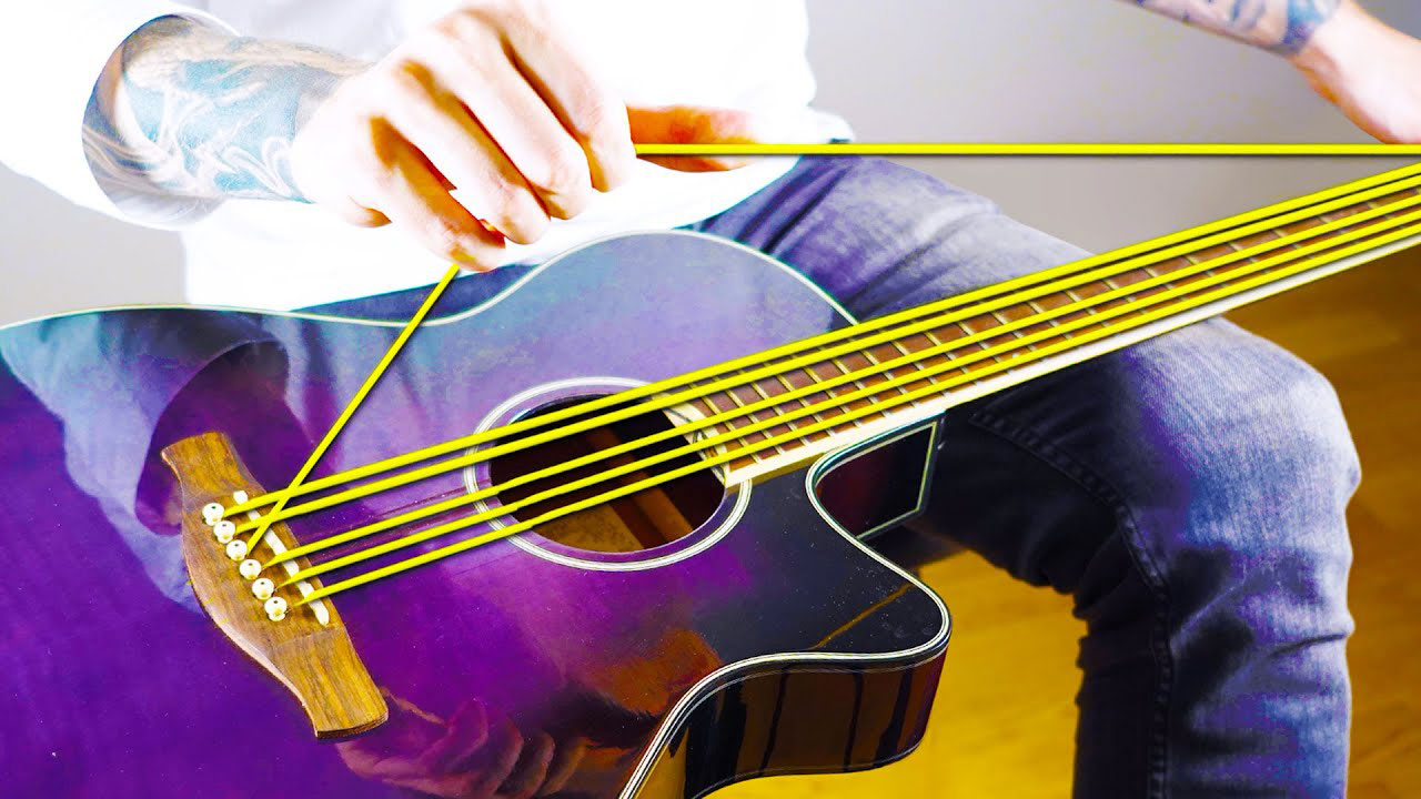 Bernth playing a rubber band-stringed acoustic guitar
