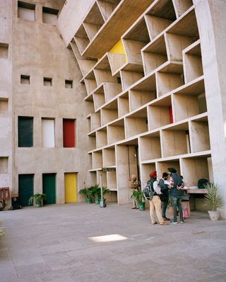 Photo of a building with colourful sections that curves at the top