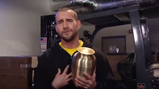 CM Punk holding Paul Bearer's urn