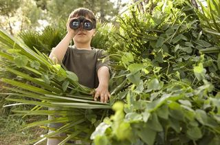 Boy looking through binoculars